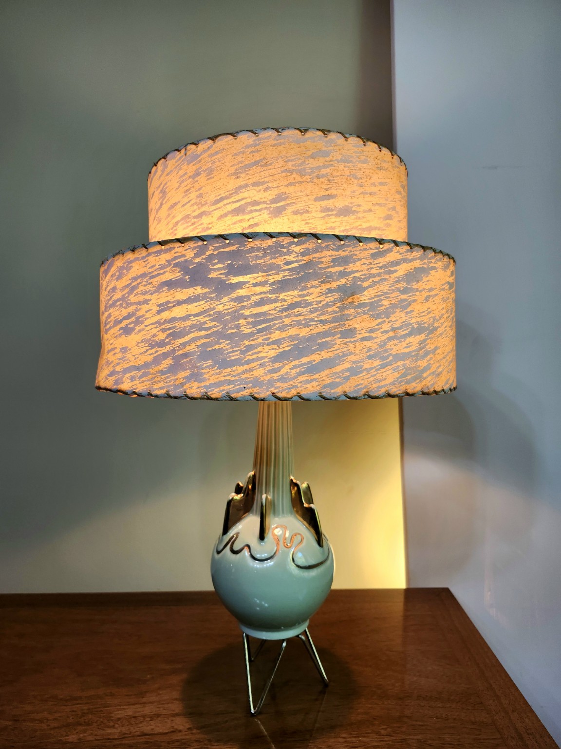 Vintage sculptural turquoise ceramic lamp with a glowing textured shade